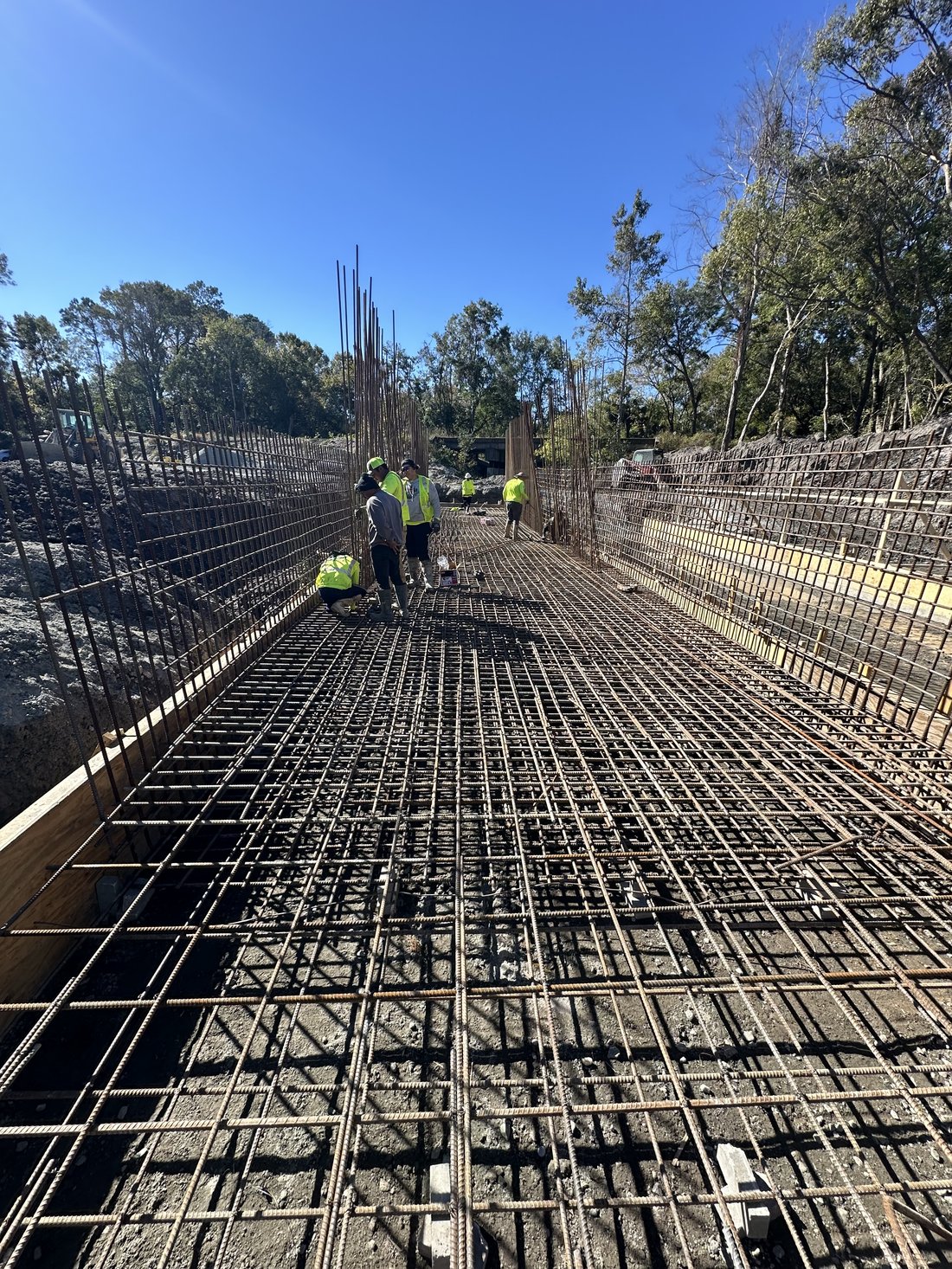 Grey Kole Construction crew reviewing a rebar deck